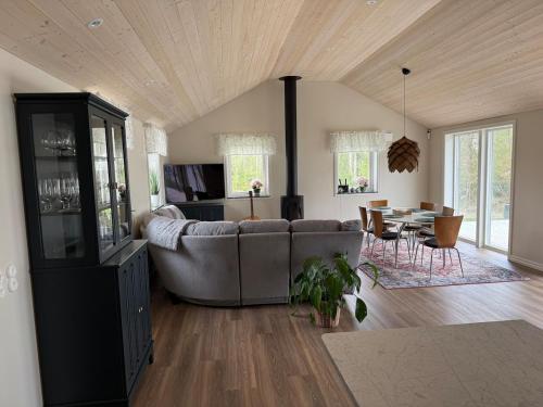 a living room with a couch and a table at Lake & Forest Escape in Skeinge in Osby