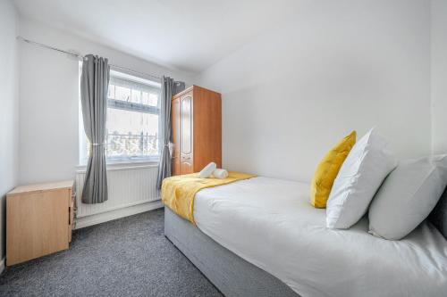 a bedroom with a large bed and a window at Luxury 3-Bedrooms House With Parking in Abbey Wood