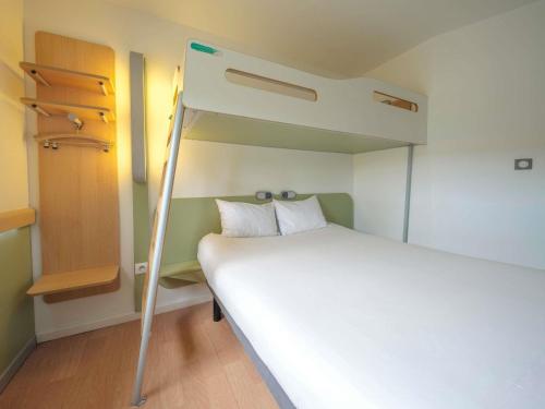 a small room with a bunk bed and a ladder at Ibis Budget Sarrebourg Buhl in Sarrebourg