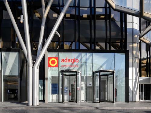 an apple office building with two revolving doors at Aparthotel Adagio Frankfurt City Messe in Frankfurt/Main