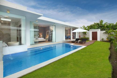a swimming pool in the backyard of a house at The Daha Luxury Villas in Seminyak