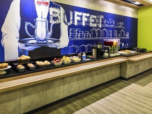a buffet line with a blender on top of it at ibis budget RJ Praia de Botafogo in Rio de Janeiro