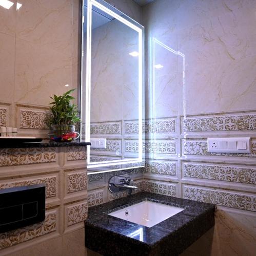 a bathroom with a sink and a window at Celestial Casa in Lucknow