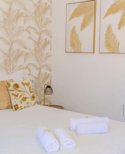 a bedroom with a bed with two towels on it at Hôtel Restaurant La Caravelle in Sari Solenzara