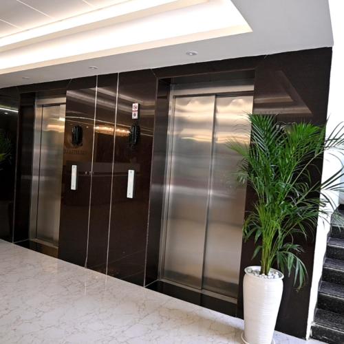 a row of elevators in a building with a potted plant at Celestial Casa in Lucknow