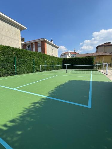 a tennis court with a net on top of it at Hotel La Pace in San Mauro Torinese