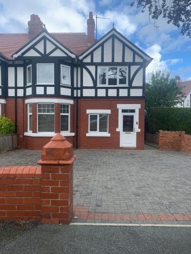 a large house with a brick driveway at Beach Hill House - Rhos on Sea in Colwyn Bay