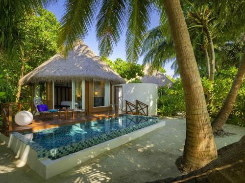 a villa with a swimming pool and a hut at Mercure Maldives Kooddoo - Adults - Only Escape - 50 percent off Transfers in Gaafu Alifu Atoll