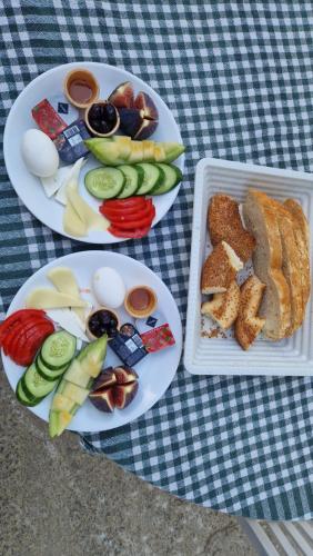 two plates of food with eggs and bread and vegetables at Mery Inn in Pamukkale