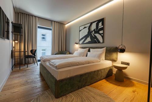 a hotel room with a large bed and a desk at Conlon House Lower East Side in Munich