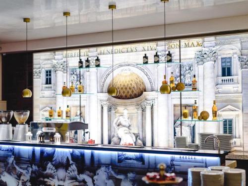 a restaurant with a mural of a building at Ibis Styles Gniezno Stare Miasto in Gniezno