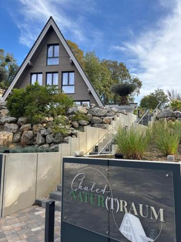 a house with a sign in front of it at Chalet NATURTRAUM in Runkel