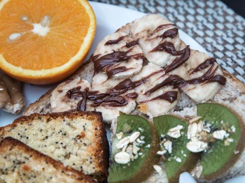 a plate of food with a piece of bread and an orange at ibis Styles Paris Mairie De Clichy in Clichy