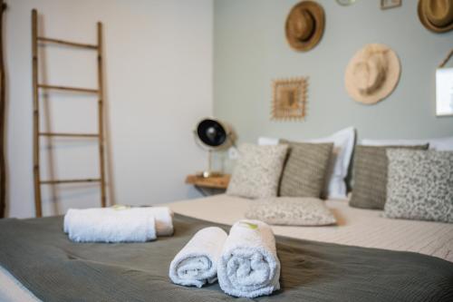 a bed with towels and pillows on it at Hôtel Restaurant La Caravelle in Sari Solenzara