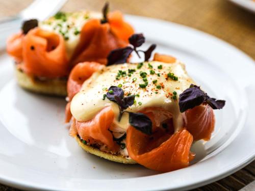 a sandwich with tomatoes and cheese on a white plate at Novotel London Canary Wharf in London