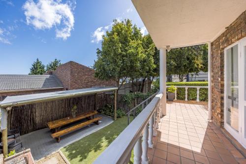 a balcony with a bench on a house at Plattekloof Premium Lodge in Plattekloof