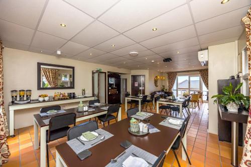 a dining room with tables and chairs in a restaurant at Plattekloof Premium Lodge in Plattekloof