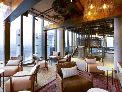 a lobby with couches and chairs in a building at Novotel London Canary Wharf in London