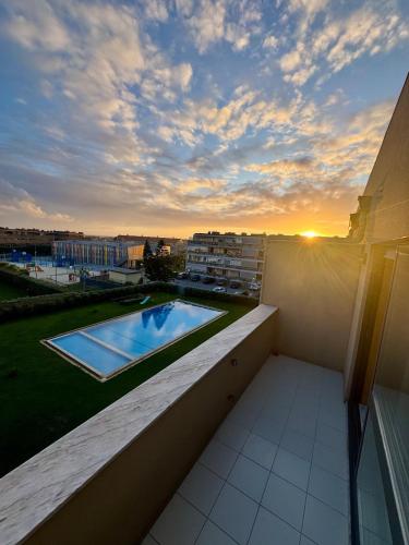 a view of a swimming pool on the balcony of a building at Serene Coastal Retreat with king Bed & Pool in Lavra in Lavra