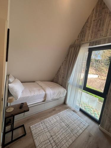 a small bedroom with a bed and a window at Chalet NATURTRAUM in Runkel