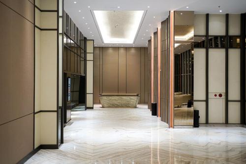 a hallway of a building with a lobby with a lobby at HARRIS Hotel Samarinda in Samarinda