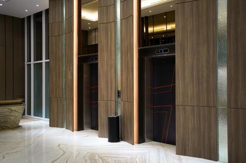 a row of glass doors in a building at HARRIS Hotel Samarinda in Samarinda