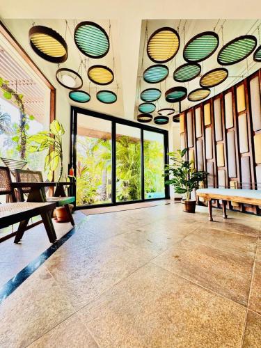 a room with a large room with large windows at HALF Hotel, Calangute in Calangute