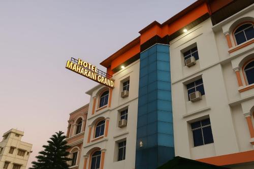 a building with a street sign on top of it at Hotel Maharani Grand Patna in Patna