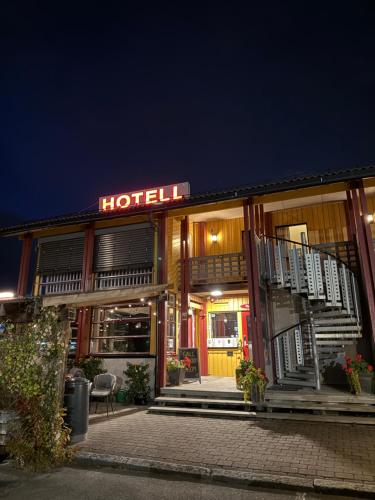 a hotel with a sign on the front of it at night at Sandmoen Bed & Breakfast, Free Parking in Trondheim