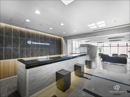 a lobby with a bar in a building at Daiwa Roynet Hotel Hamamatsu in Hamamatsu