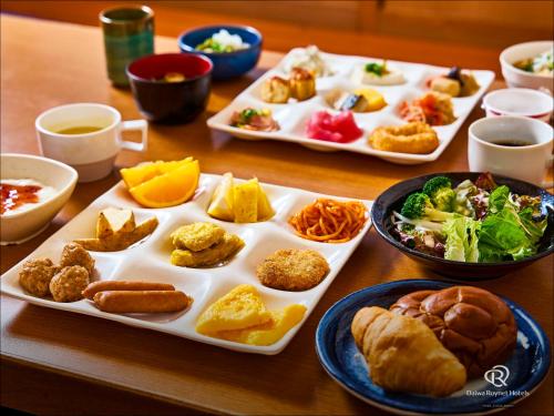 a table with two trays of food on it at Daiwa Roynet Hotel Hamamatsu in Hamamatsu