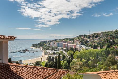 a view of a city and the ocean from a building at Villa Bellevue Portoroz-Portorose in Portorož