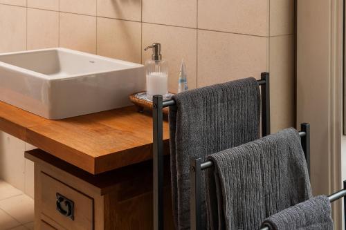 a bathroom with a sink and two towels on a counter at Quarter House in Broughton