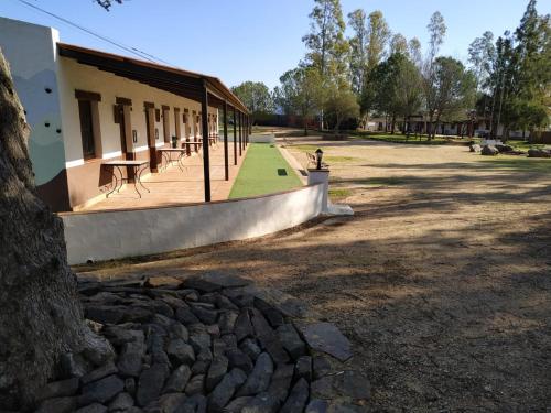 a park with a building and a table and benches at Waingunga in Lepe