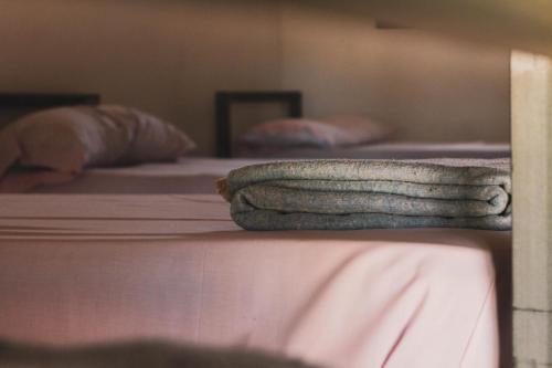 two pillows sitting on a bed in a room at Waingunga in Lepe
