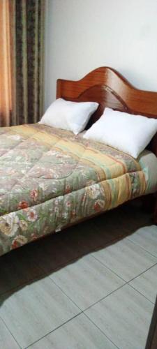 a bedroom with a bed with a wooden head board at Holliday inn kigali in Kigali