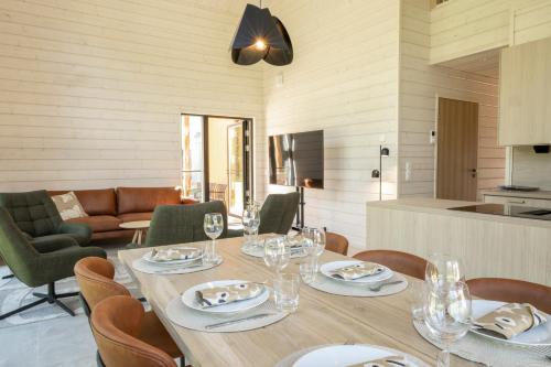 a dining room with a table with wine glasses at Villa Uleå - Villa Oulu in Oulu
