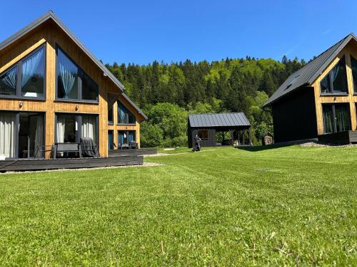 a house with a large yard in front of it at Siedlisko Widzimy Się in Baligród