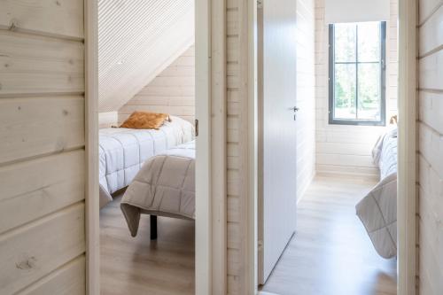 a hallway with a bed and a chair in a room at Villa Uleå - Villa Oulu in Oulu