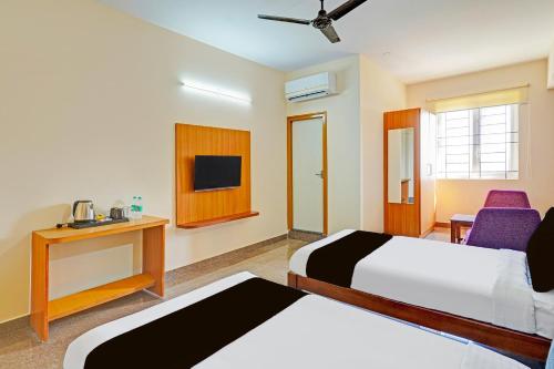 a hotel room with two beds and a tv at Hotel Golden Prime in New Delhi