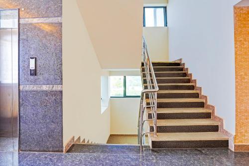 a staircase in a building with blue tiles at Hotel Golden Prime in New Delhi