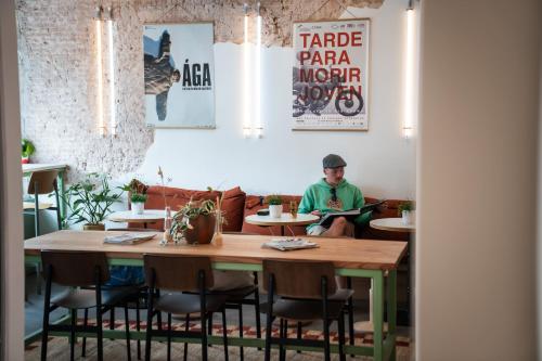 a man sitting at a table in a restaurant at Will & Tate City Stay in The Hague