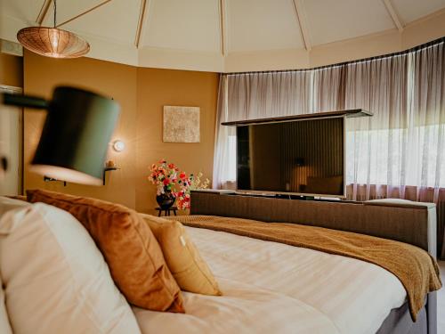 a bedroom with a large bed and a large mirror at Hotel Heemskerk in Heemskerk