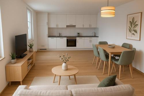 a living room and kitchen with a table and a couch at Family Suite 