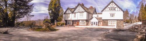 a rendering of a large house with a driveway at Lindeth Howe in Bowness-on-Windermere