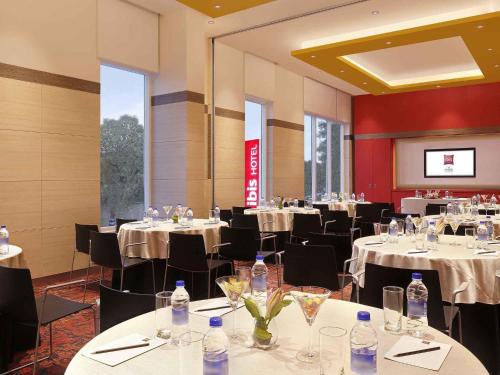 a dining room with tables and chairs with water bottles at ibis Coimbatore City Centre - An Accor Brand in Coimbatore