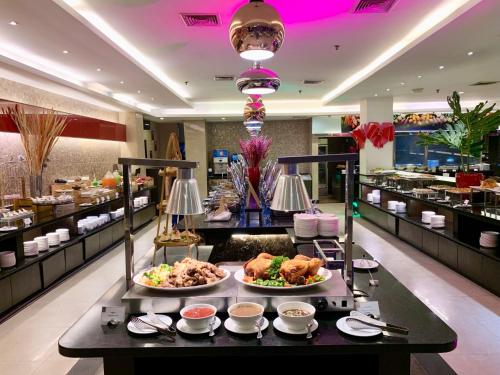 a buffet in a restaurant with several plates of food at Sima Thani Hotel in Nakhon Ratchasima