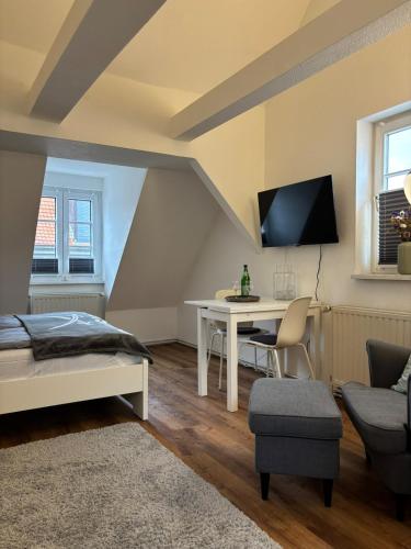 a bedroom with a bed and a desk and a couch at Ferienwohnung Mitten drin Bad Arolsen in Bad Arolsen