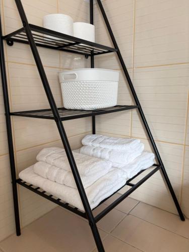 a group of towels on a shelf in a bathroom at Stari Bar Apartments in Stari Bar