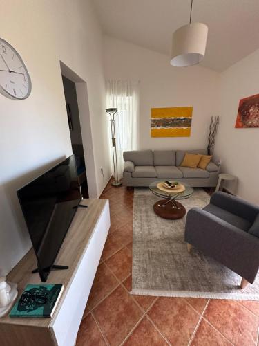 a living room with a couch and a tv at Stari Bar Apartments in Stari Bar